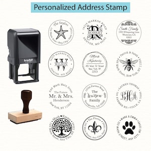 May include: A black self-inking Trodat stamp and a wooden handle rubber stamp are displayed alongside twelve circular black ink impressions featuring various personalized address designs, including names, street addresses, and graphic icons.