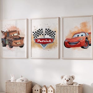 May include: Set of three framed watercolor prints featuring cartoon cars. One print shows a brown tow truck, another has a checkered flag design with the name "Patrick", and the third depicts a red race car. The prints are displayed on a white wall.