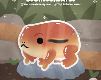 May include: A cartoon illustration of a red and orange frog sitting on a gray rock. The frog has a black stripe across its eye and a white belly. The background is a green and brown forest.