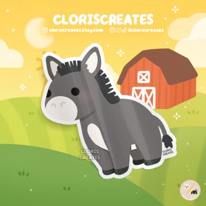 May include: A cartoon gray donkey with white markings stands in front of a red barn with a white X on the side. The donkey has a black mane and tail. The background is a yellow and green field.
