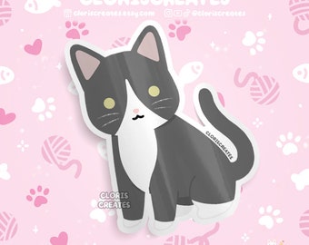 May include: A black and white cat sticker with yellow eyes. The cat is sitting on a pink background with white paw prints and hearts. The sticker has the text "CLORIS CREATES" on it.