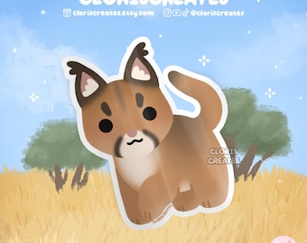 May include: A sticker featuring a cartoon caracal cat with a tan body, black markings, and large ears. The sticker has a white border and is set against a background of blue sky and yellow grass. The text "CLORISCREATES" is at the top.
