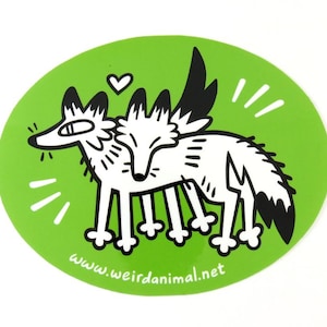 May include: An oval sticker with a bright green background featuring a black and white line art illustration of two foxes standing together. A small heart is above them, and the text www.weirdanimal.net is printed at the bottom.