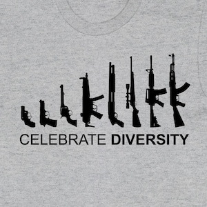 May include: A grey t-shirt featuring a black silhouette of various guns arranged in a line. The words "Celebrate Diversity" are printed beneath the guns.