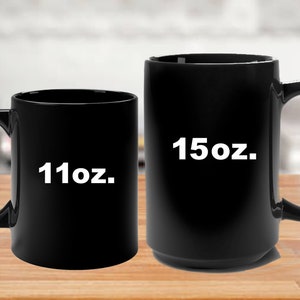 May include: Two black ceramic coffee mugs, one 11oz and one 15oz.