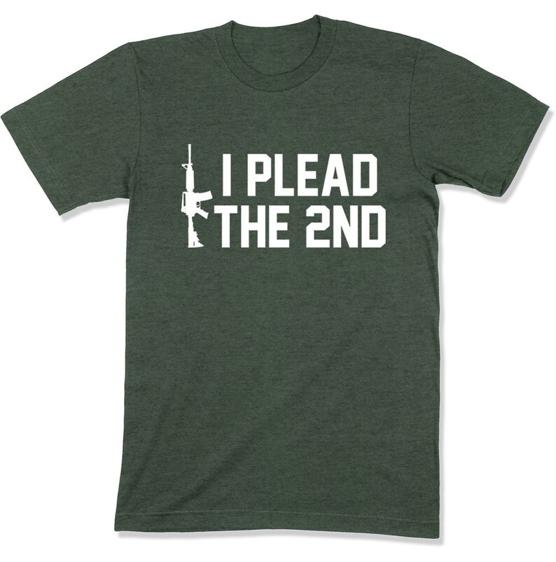 May include: A dark green t-shirt with a white silhouette of a rifle and the text "I PLEAD THE 2ND".