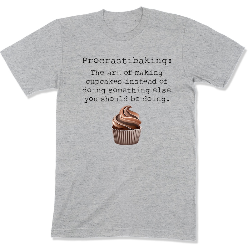 May include: Gray t-shirt with the text "Procrastibaking: The art of making cupcakes instead of doing something else you should be doing." and a chocolate cupcake illustration.