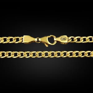 May include: A gold chain necklace with a curb link design. The chain has a lobster clasp closure and a 14k stamp.