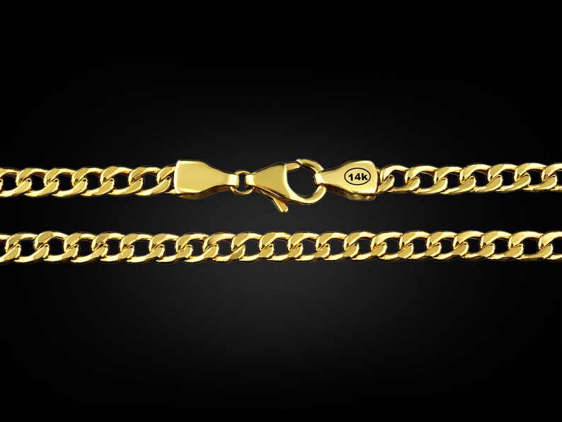 May include: A gold chain necklace with a curb link design. The chain has a lobster clasp closure and a 14k stamp.
