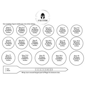 May include: A ring size guide with a ruler and circles showing different ring sizes in millimeters and inches. The guide is printed on a white background with a black and silver logo at the top.