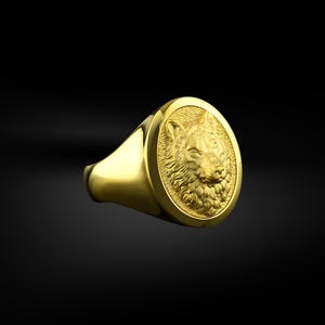 May include: A gold ring with a detailed wolf head design. The wolf's head is in high relief and has a textured fur pattern.
