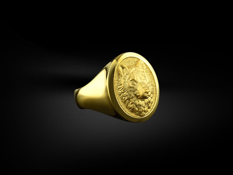 May include: A gold ring with a detailed wolf head design. The wolf's head is in high relief and has a textured fur pattern.