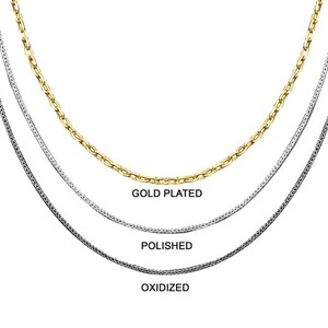 May include: Three silver chains, one gold plated, one polished, and one oxidized. The chains are layered on top of each other.