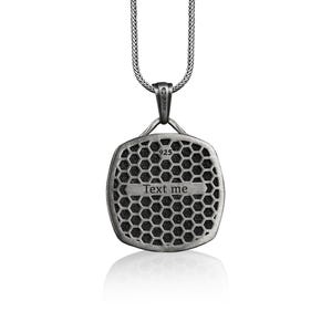 May include: Silver pendant necklace with a square-shaped pendant featuring a honeycomb pattern and the text "Text me".