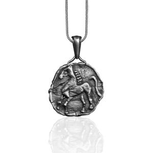 May include: Silver pendant necklace featuring a detailed relief of a horse. The pendant is oval shaped and hangs from a silver chain.