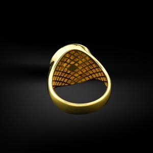 May include: A gold ring with a textured design on the inside of the band.