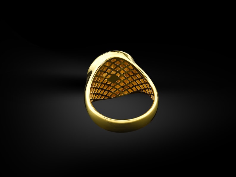May include: A gold ring with a textured design on the inside of the band.