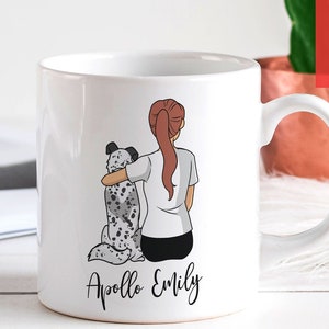 May include: White ceramic mug with a personalized illustration of a woman with red hair and a dog. The text "Apollo Emily" is printed on the mug.
