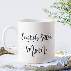 May include: White ceramic coffee mug with black text that reads "English Setter Mom".