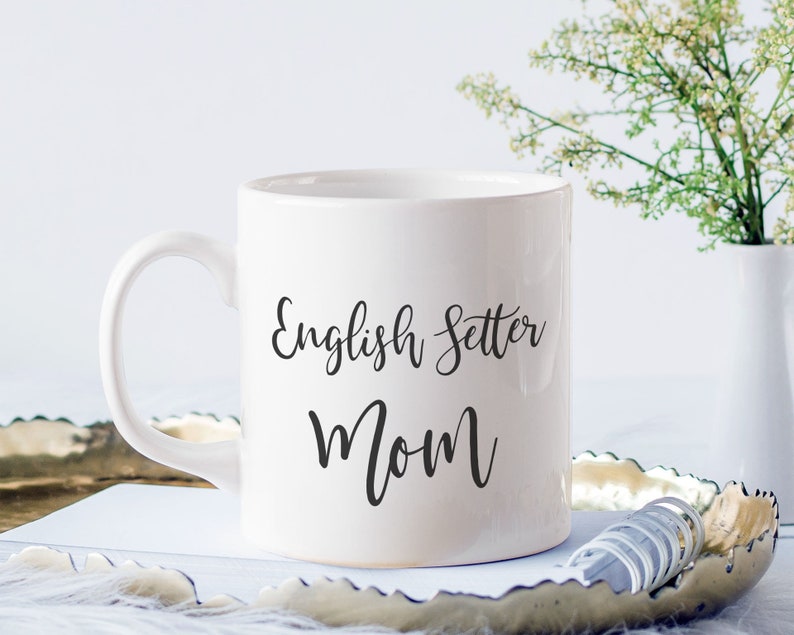 May include: White ceramic coffee mug with black text that reads "English Setter Mom".