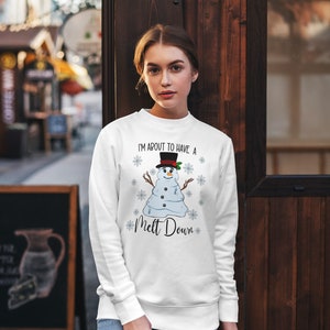 May include: White sweatshirt with a melting snowman graphic and the text "I'm about to have a melt down".
