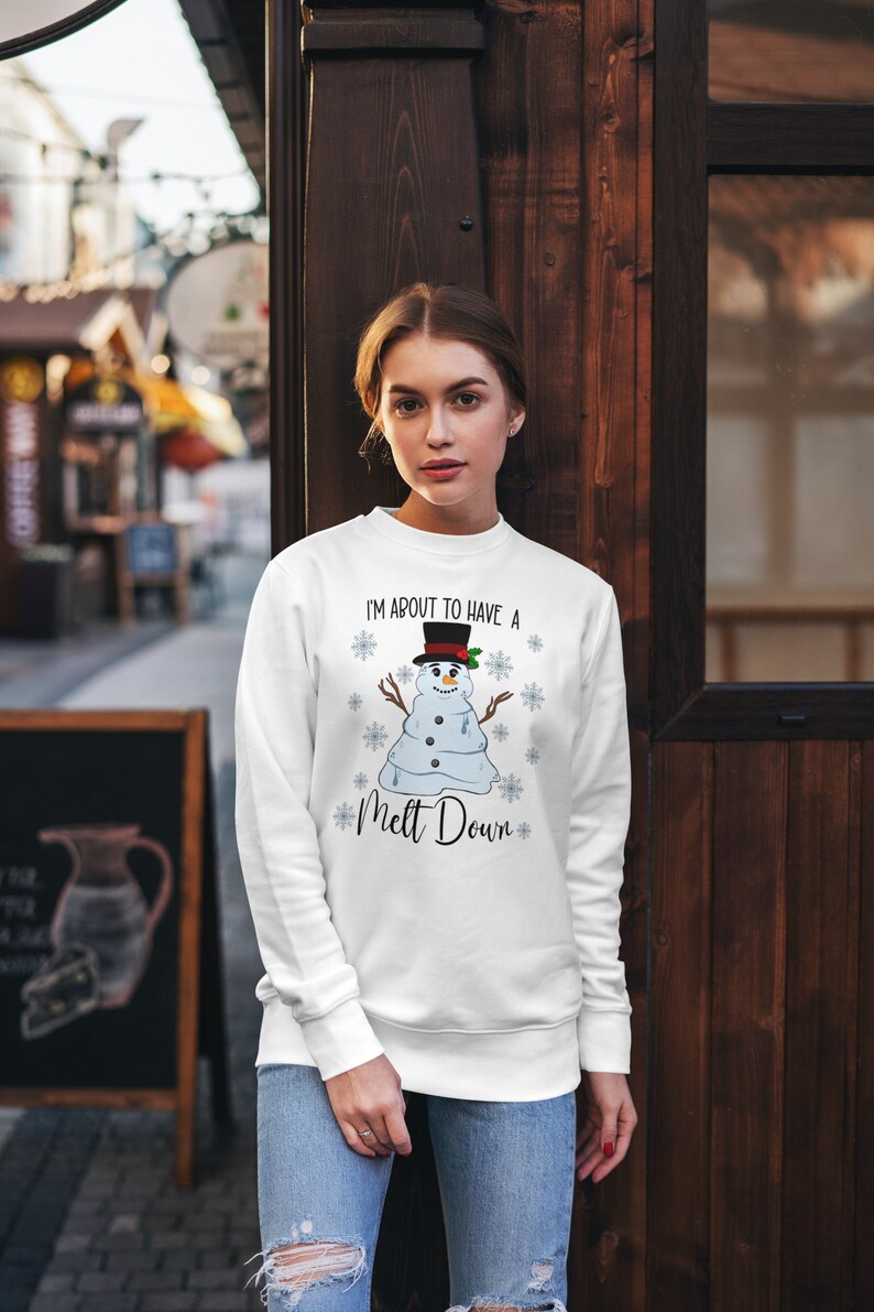May include: White sweatshirt with a melting snowman graphic and the text "I'm about to have a melt down".