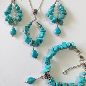 May include: Turquoise gemstone jewelry set with a necklace, earrings, and bracelet. The necklace and earrings feature a teardrop-shaped pendant and a circular design. The bracelet is made of turquoise stones and silver.