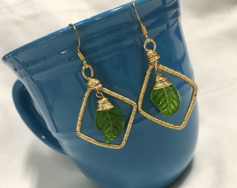 Handmade gold wire-wrapped rhombus and wire-wrapped glass leaf earrings