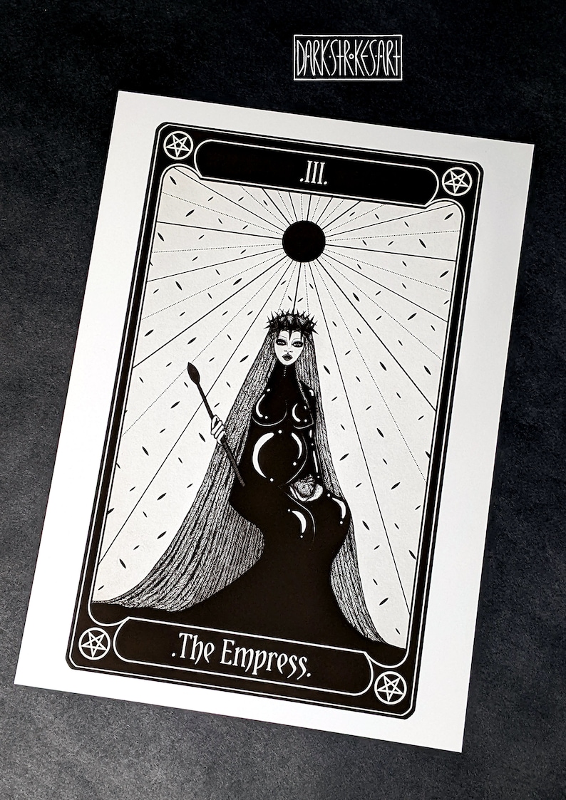 May include: Black and white tarot card illustration of The Empress, card number III. The Empress is depicted as a woman wearing a crown and a long flowing gown. She is holding a staff and a crescent moon.