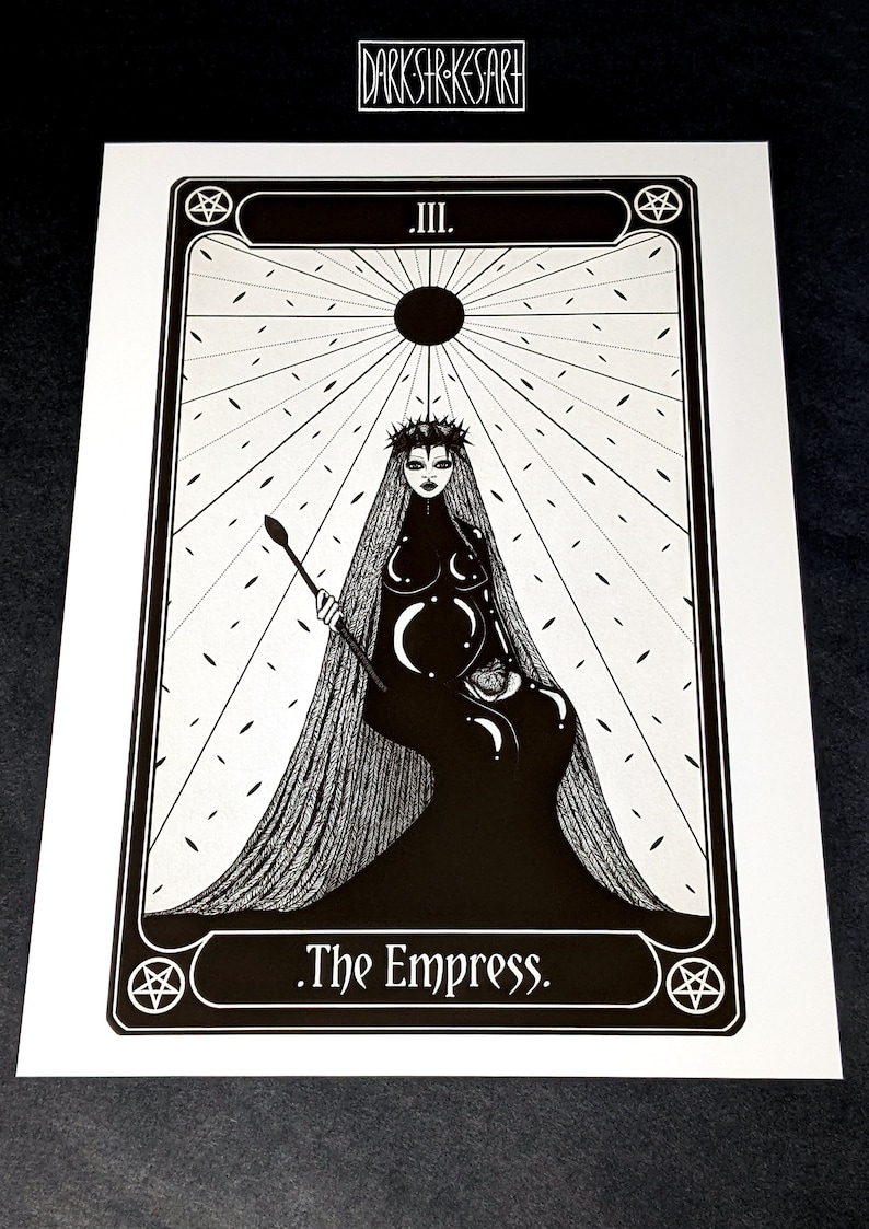 May include: Black and white illustration of The Empress tarot card. The card features a woman with a crown and long hair, sitting on a throne. The background is a radiating sun with a pentagram in the corner.