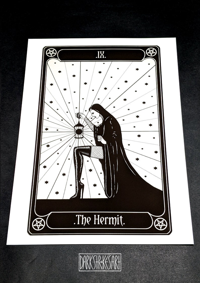 May include: Black and white illustration of The Hermit tarot card. The card features a woman in a hooded robe holding a lantern, with a pentagram in the corner. The text "IX. The Hermit." is at the bottom of the card.