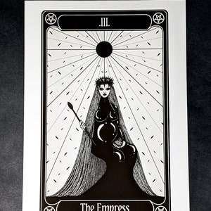 May include: Black and white illustration of The Empress tarot card. The card features a woman wearing a crown and a veil, holding a staff. The card is surrounded by a pentagram and the Roman numeral III.