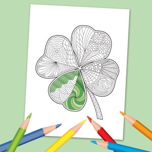 May include: A black and white line drawing of a four-leaf clover with intricate patterns in each leaf. The clover is surrounded by five colored pencils: red, orange, yellow, blue, and green.