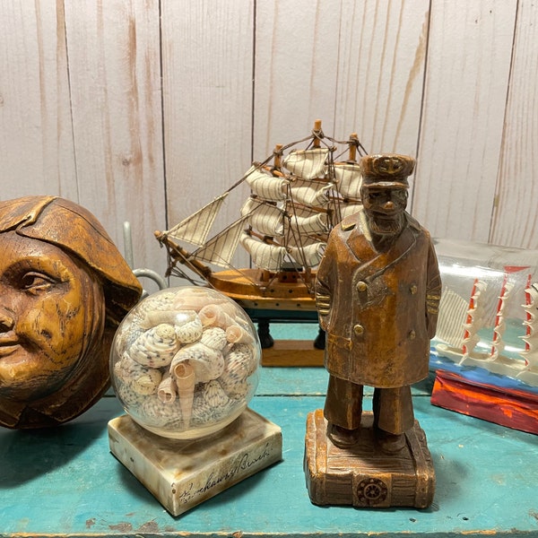 nautical themed trinkets, vintage syroco sea captain figurine, shell collection, ship in bottle, desk display, home office, beach decor