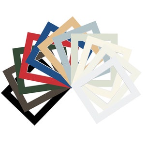 May include: A set of 12 picture frames in various colours, including black, white, red, blue, green, and beige. The frames are arranged in a fan shape, with the white frame in the centre.