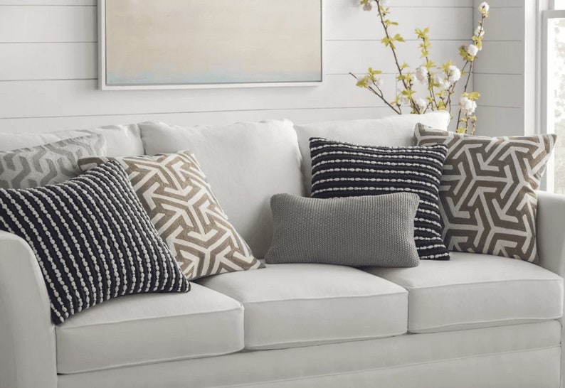 @homegoods throw pillows on @zgallerie leather sectional sofa in family room. #H