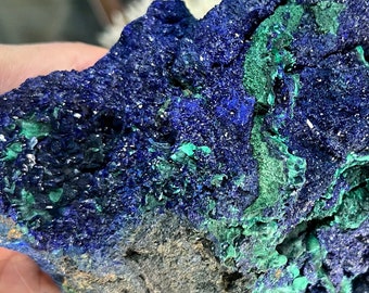 May include: Azurite and malachite specimen with a deep blue and green color. The mineral has a rough, textured surface.
