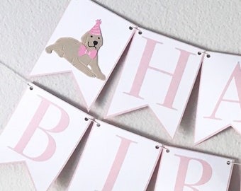 May include: Pink and white banner with the words "Happy Birthday" and two small dogs wearing pink hats.