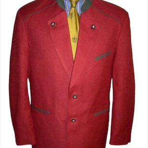 May include: A red blazer with a green collar and trim. The blazer has a single button closure and two pockets. The blazer is worn over a yellow and blue patterned shirt.
