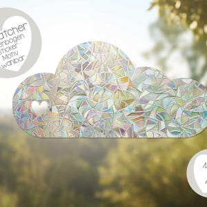 May include: An iridescent rainbow suncatcher sticker in the shape of a cloud with a heart cutout. The sticker is labelled "Suncatcher Regenbogen Sticker Motiv Wahlbar".