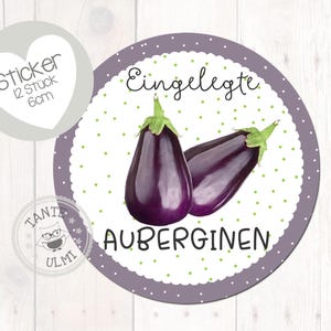 Peut inclure: Autocollant violet et blanc avec le texte "Einglegte Auberginen" et un fond à pois. L'autocollant représente deux aubergines violettes. L'autocollant a un diamètre de 6 cm.