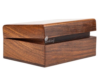 May include: A wooden box with a hinged lid. The box is made of dark brown wood with a natural wood grain pattern. The lid is slightly ajar, revealing the interior of the box.