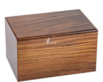 May include: A wooden box with a light brown finish. The box has a simple design and is made of high-quality wood.