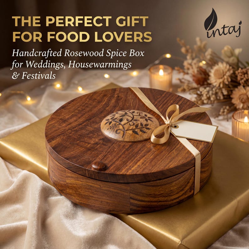 Handcrafted rosewood spice box by INTAJ, round masala dabba with 9 compartments for spices, herbs or dry fruits. Features intricate floral carving on the lid, smooth polished finish and food-safe interior, perfect wooden spice box and kitchen organizer for everyday cooking. Beautiful boho farmhouse décor accent and thoughtful housewarming, wedding or Christmas gift for home chefs and spice lovers, 8.8 inch Indian spice box for countertop storage.
