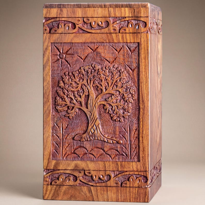 Rosewood Tree of Life urn with peaceful birds, handmade from solid, legally sourced wood, shown in multiple lifestyle scenes for ashes burial, home memorial display, columbarium niches and scattering in nature. Features secure sliding bottom opening with screw, TSA-approved design for travel, and size options from keepsake to XX-large family urn. Warm, comforting finish blends with modern décor, creating a meaningful, dignified tribute and thoughtful sympathy gift.