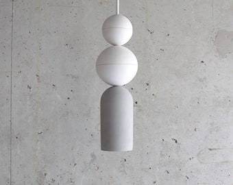 May include: A modern pendant light fixture with a gray cylindrical base and three white spherical shades.