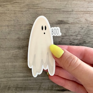May include: A white ghost sticker with a surprised expression and the word "BOO." printed on it.