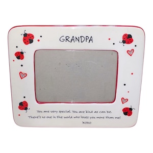 May include: A white ceramic photo frame with a red border, featuring the word "GRANDPA" in black. Adorned with red ladybugs, hearts, and the text "You are very special..." and "XOXO".