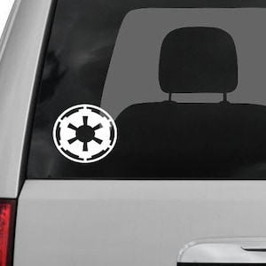 May include: A white vinyl decal of the Imperial symbol from Star Wars. The symbol is a circle with a black center and a white starburst design.