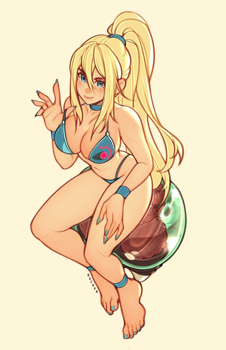 May include: A blonde-haired woman with blue eyes wearing a blue bikini with a pink and red symbol on the top. She is sitting on a green and brown object with her legs crossed.
